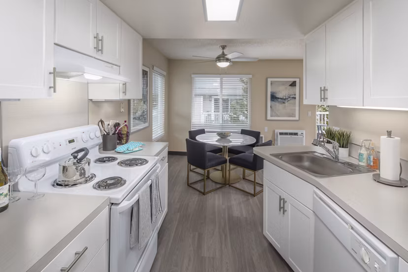 Kitchen featuring modern appliances and sleek cabinetry at Summerfield Apartments