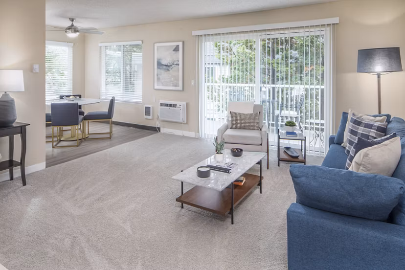 Spacious living room with modern furniture and natural light in Summerfield Apartments, a luxury Greystar property
