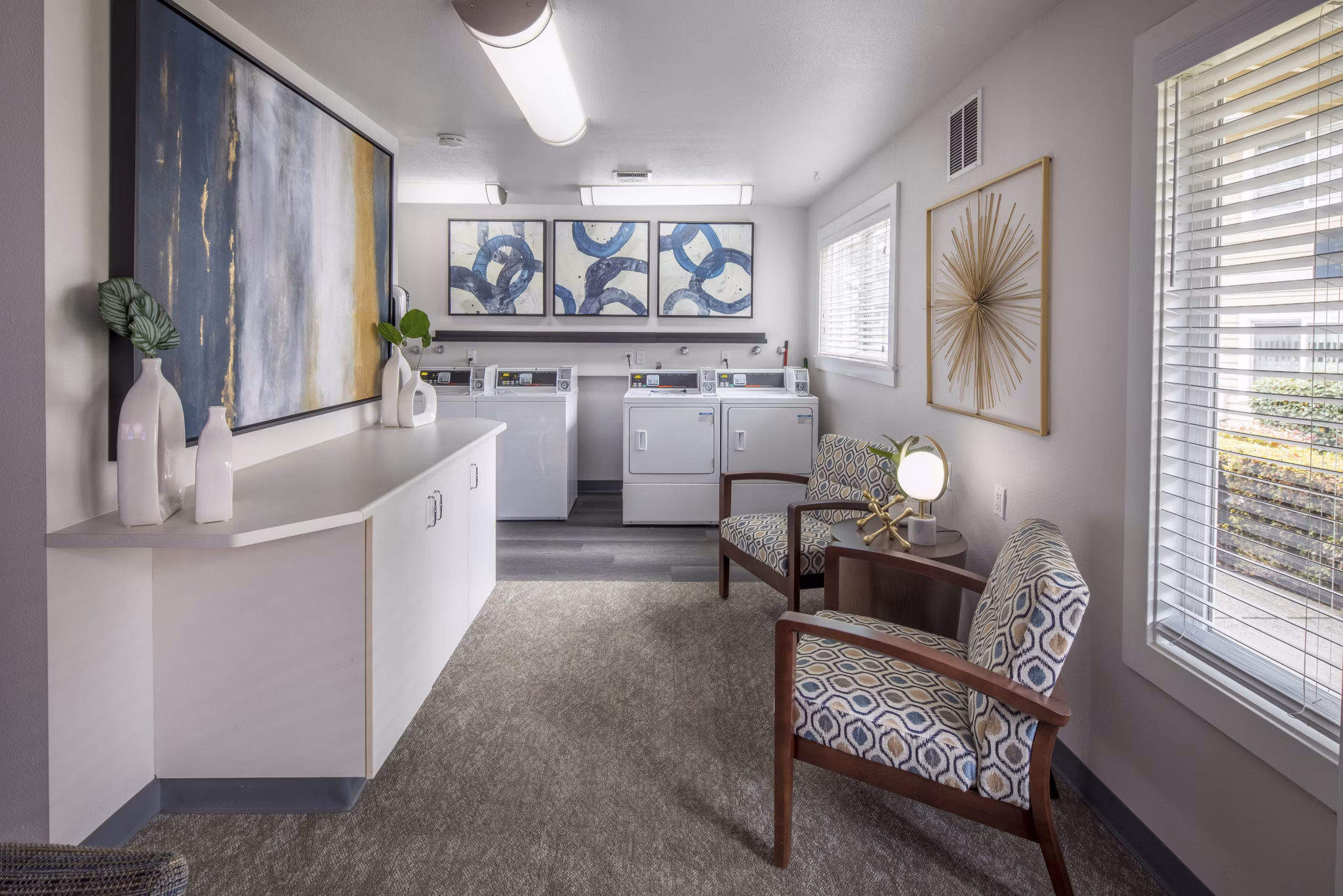 Laundry room with modern machines at Summerfield Apartments, offering convenient amenities for residents seeking quality living experiences