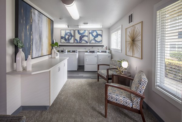 Laundry room with modern machines at Summerfield Apartments, offering convenient amenities for residents seeking quality living experiences