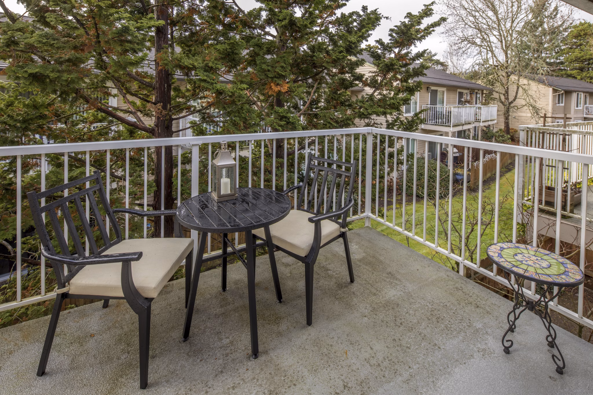 Charming patio with outdoor seating at Summerfield Apartments, ideal for relaxing and socializing in a luxury setting