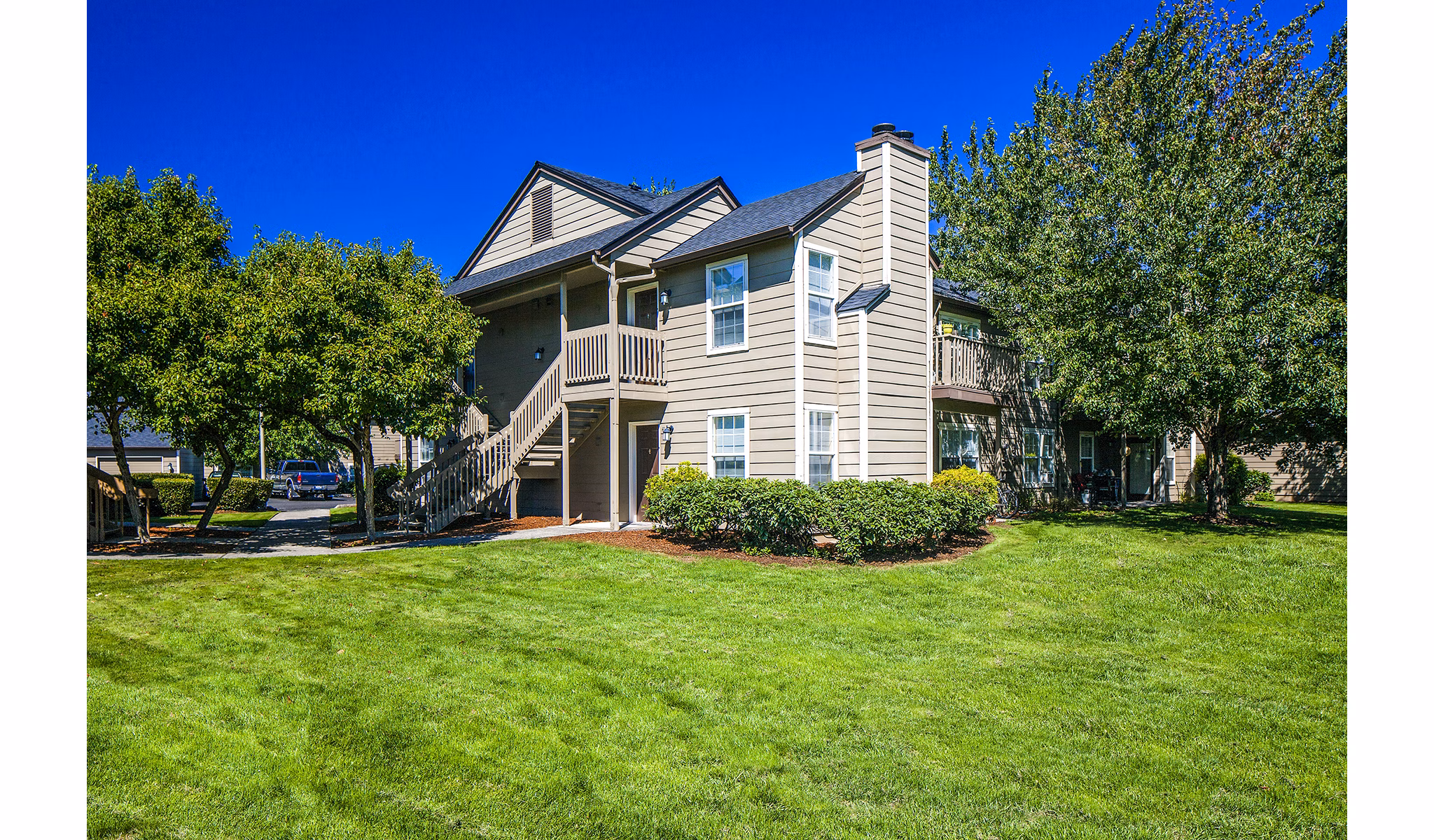 Village at Cascade Park: Contemporary apartment building with landscaped gardens in a vibrant community setting