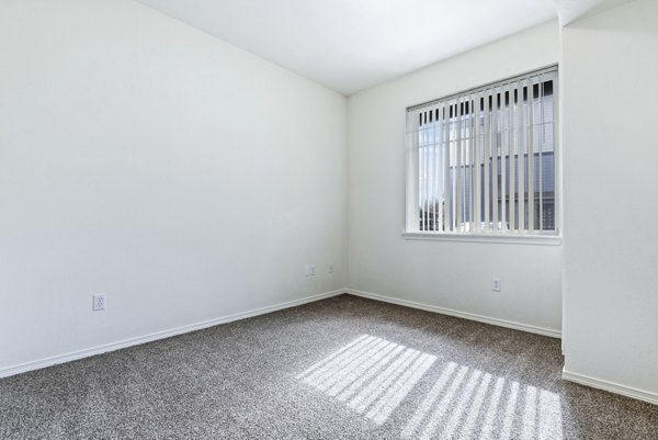 Bedroom with contemporary design elements at Logger Creek at Parkcenter Apartments