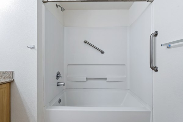 Bathroom featuring modern fixtures and sleek design at Logger Creek at Parkcenter Apartments