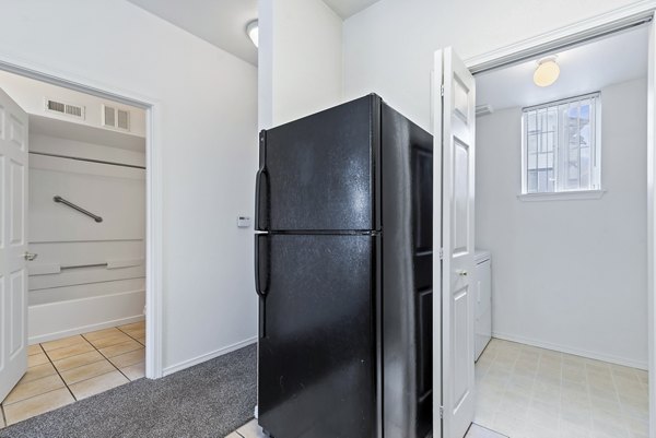 Modern kitchen with stainless steel appliances at Logger Creek at Parkcenter Apartments