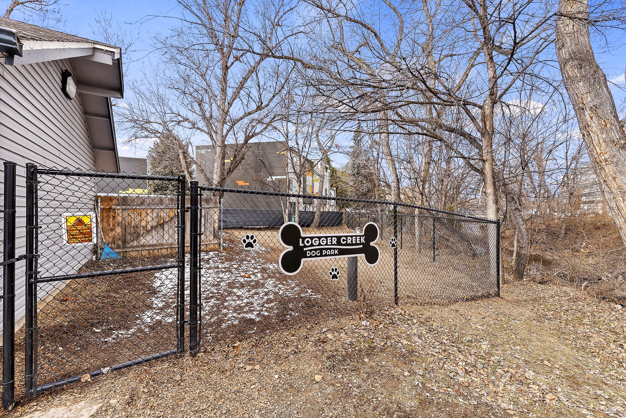 Expansive dog park with agility equipment at Logger Creek at Parkcenter Apartments, ideal for pet-friendly luxury living