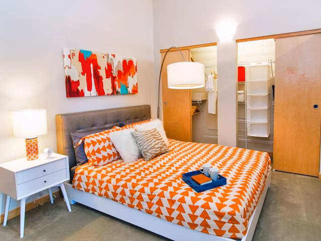 Cozy bedroom with modern decor at Museum Place Apartments, a Greystar luxury property in the heart of the city