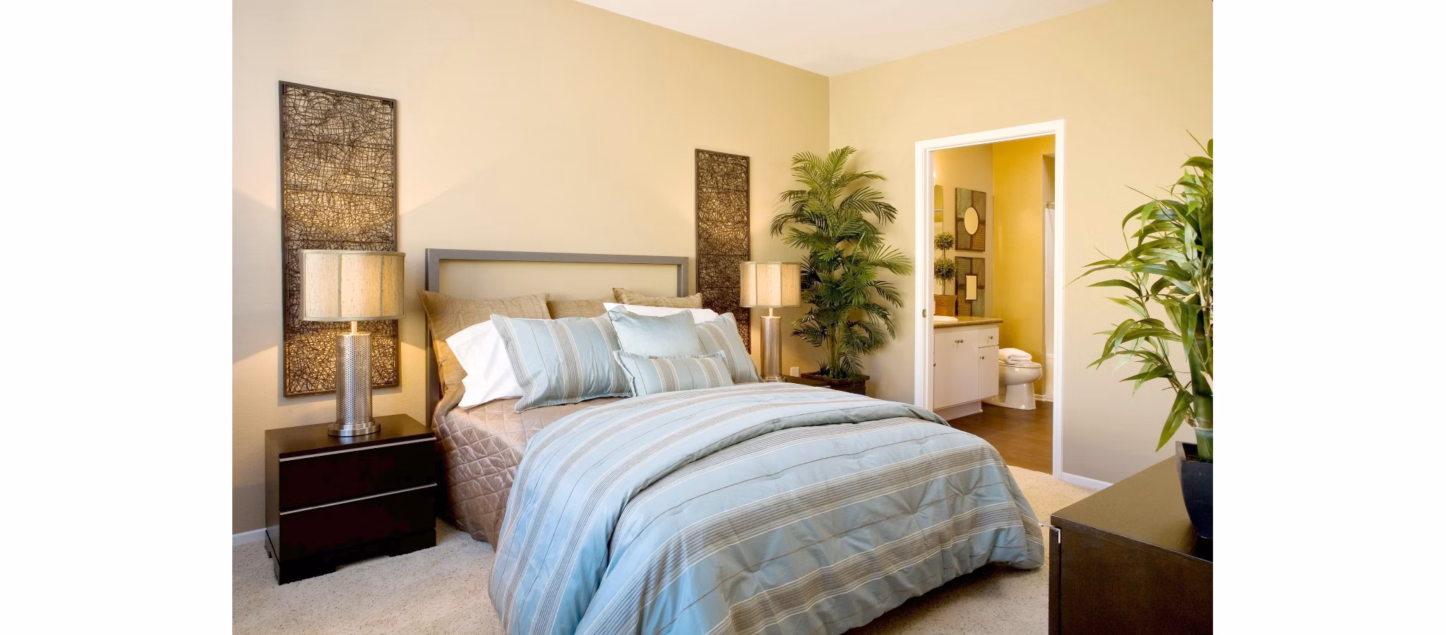 Cozy bedroom featuring modern furnishings and large window in Castlerock Apartments