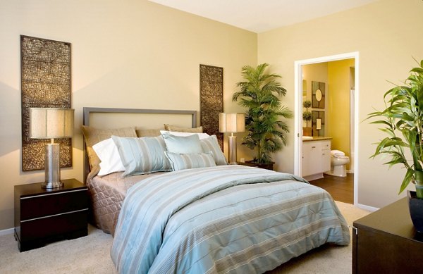 Cozy bedroom featuring modern furnishings and large window in Castlerock Apartments