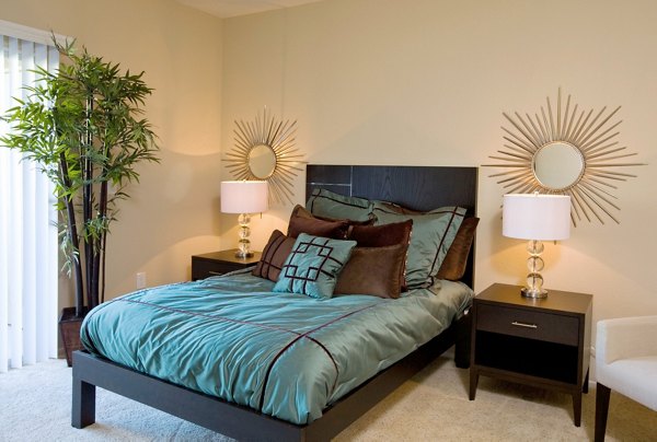Bedroom featuring modern decor and ample natural light at Castlerock Apartments
