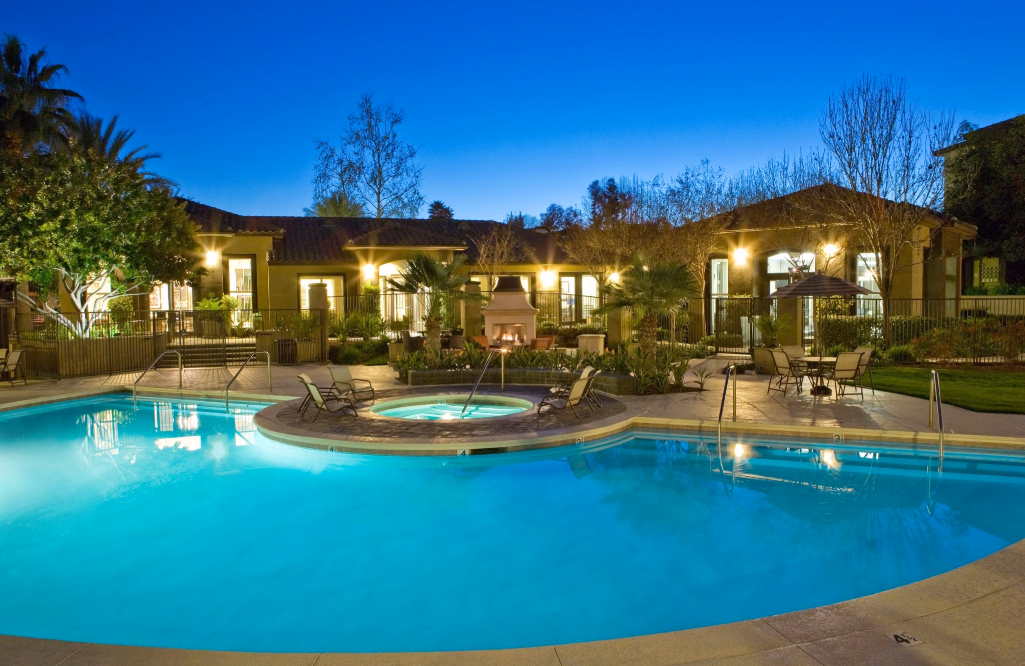 Outdoor pool with lounging chairs at Castlerock Apartments offering relaxation and recreation