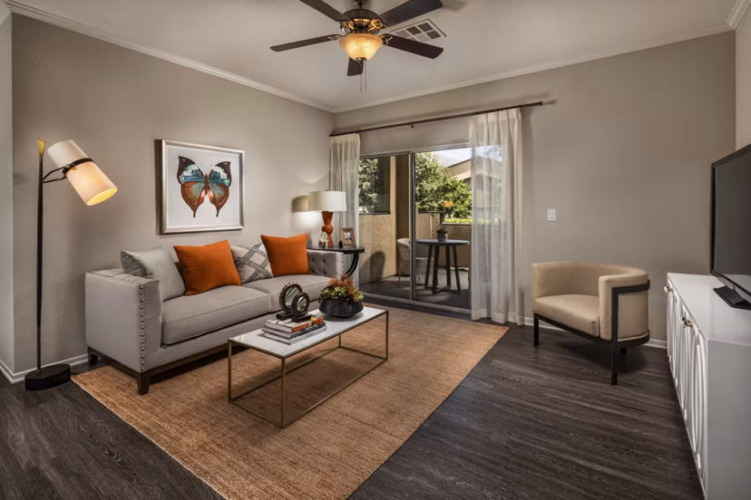 Spacious living room with modern decor in Colonnade Apartments, a Greystar luxury community