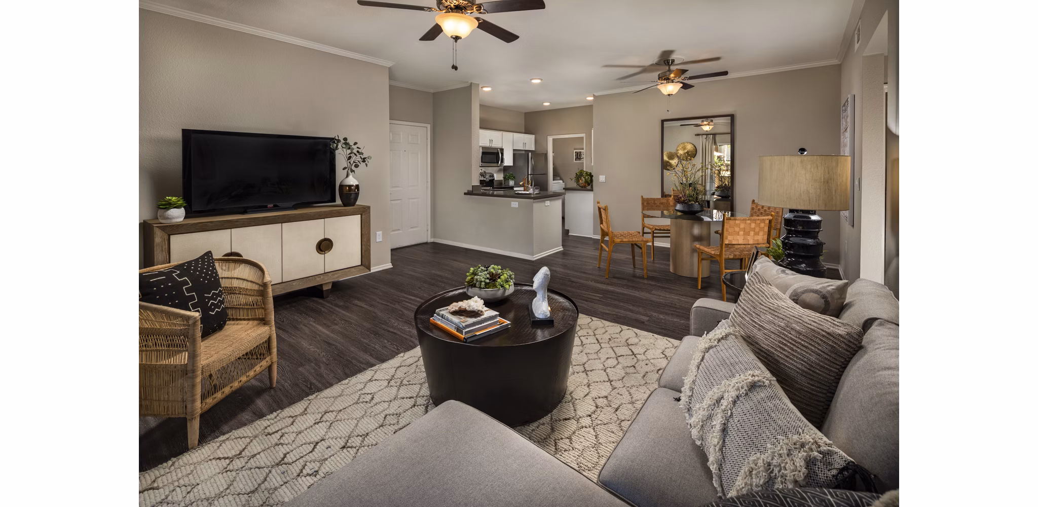 Modern living room with sleek furniture and large windows at Colonnade Apartments