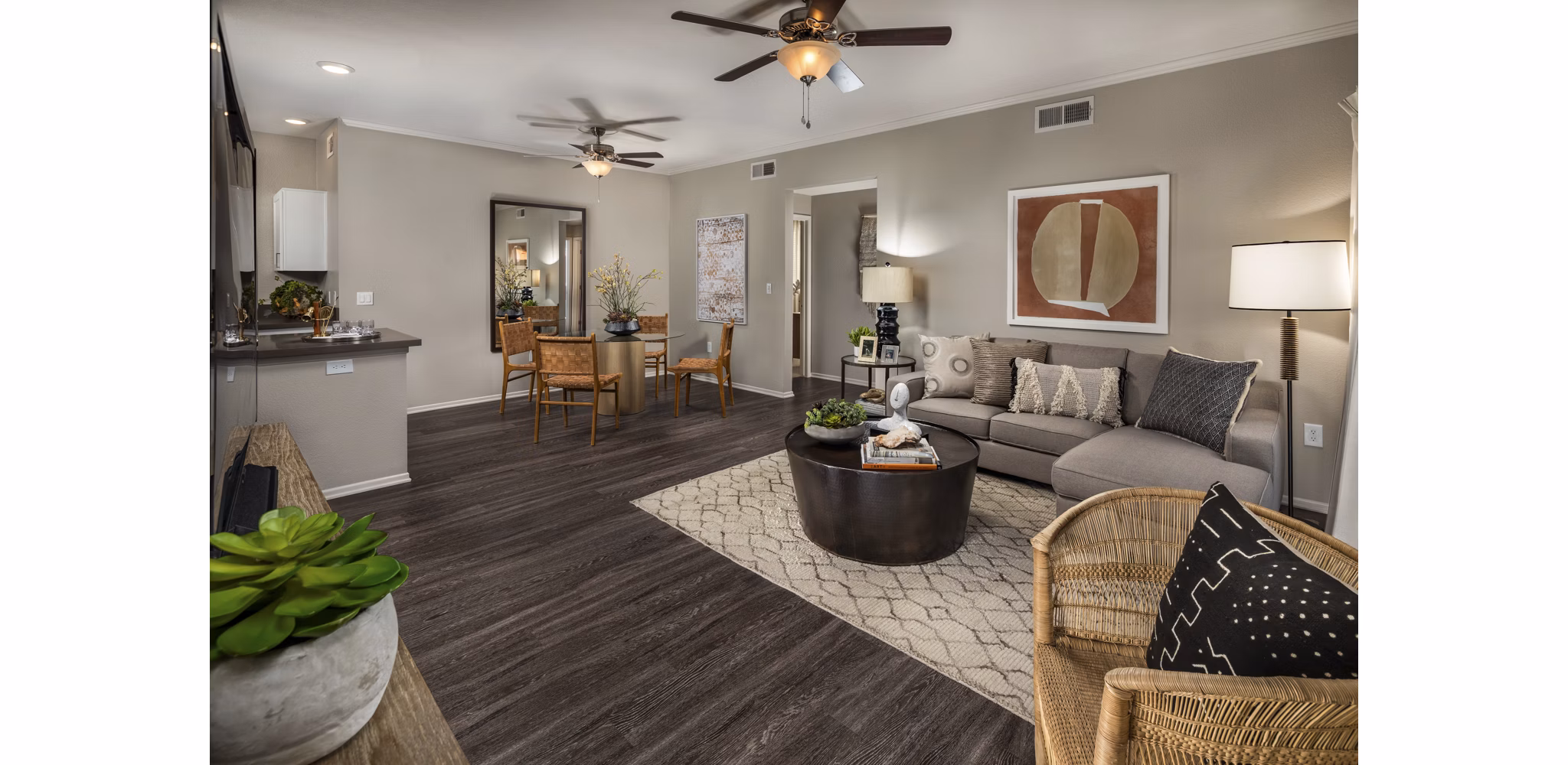 Spacious living room with modern decor and large windows in Colonnade Apartments