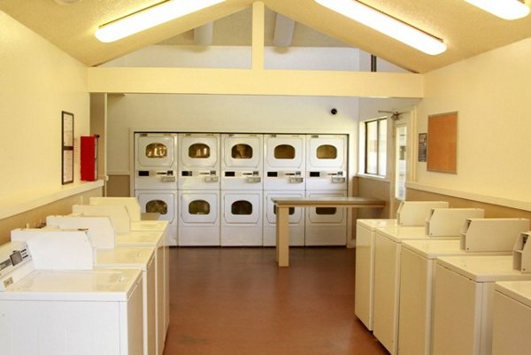 La Vista Apartments: Modern laundry facility with advanced appliances in a Greystar community