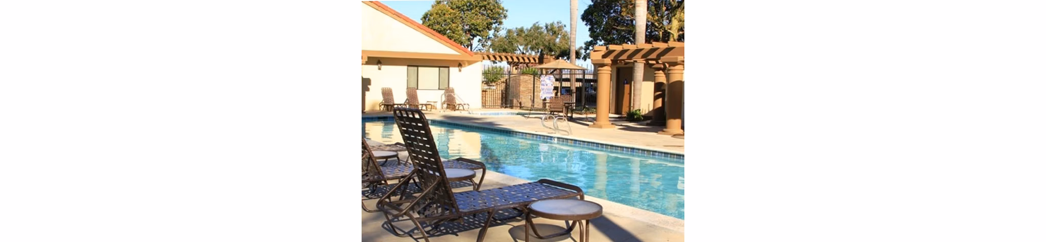 Resort-style pool with lounge areas at La Vista Apartments, perfect for relaxation and leisure