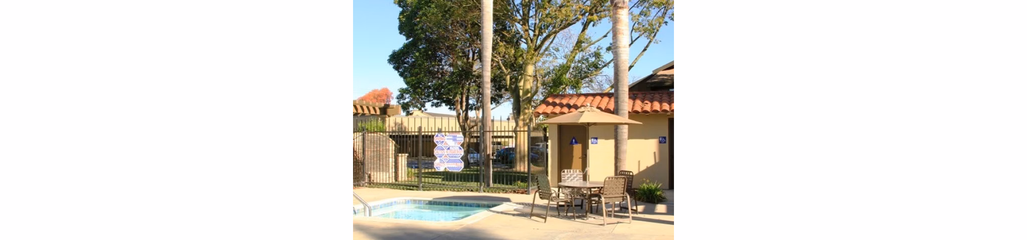 Resort-style pool at La Vista Apartments with luxury lounge seating and lush greenery
