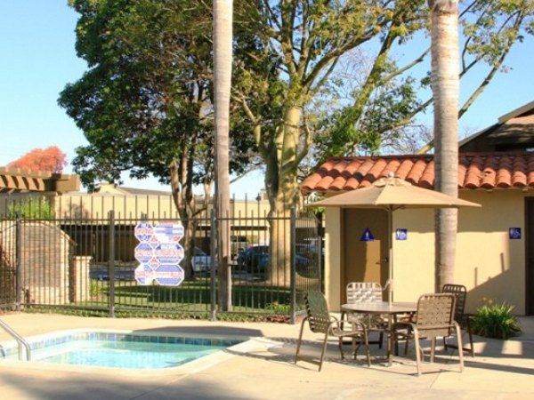 Resort-style pool at La Vista Apartments with luxury lounge seating and lush greenery