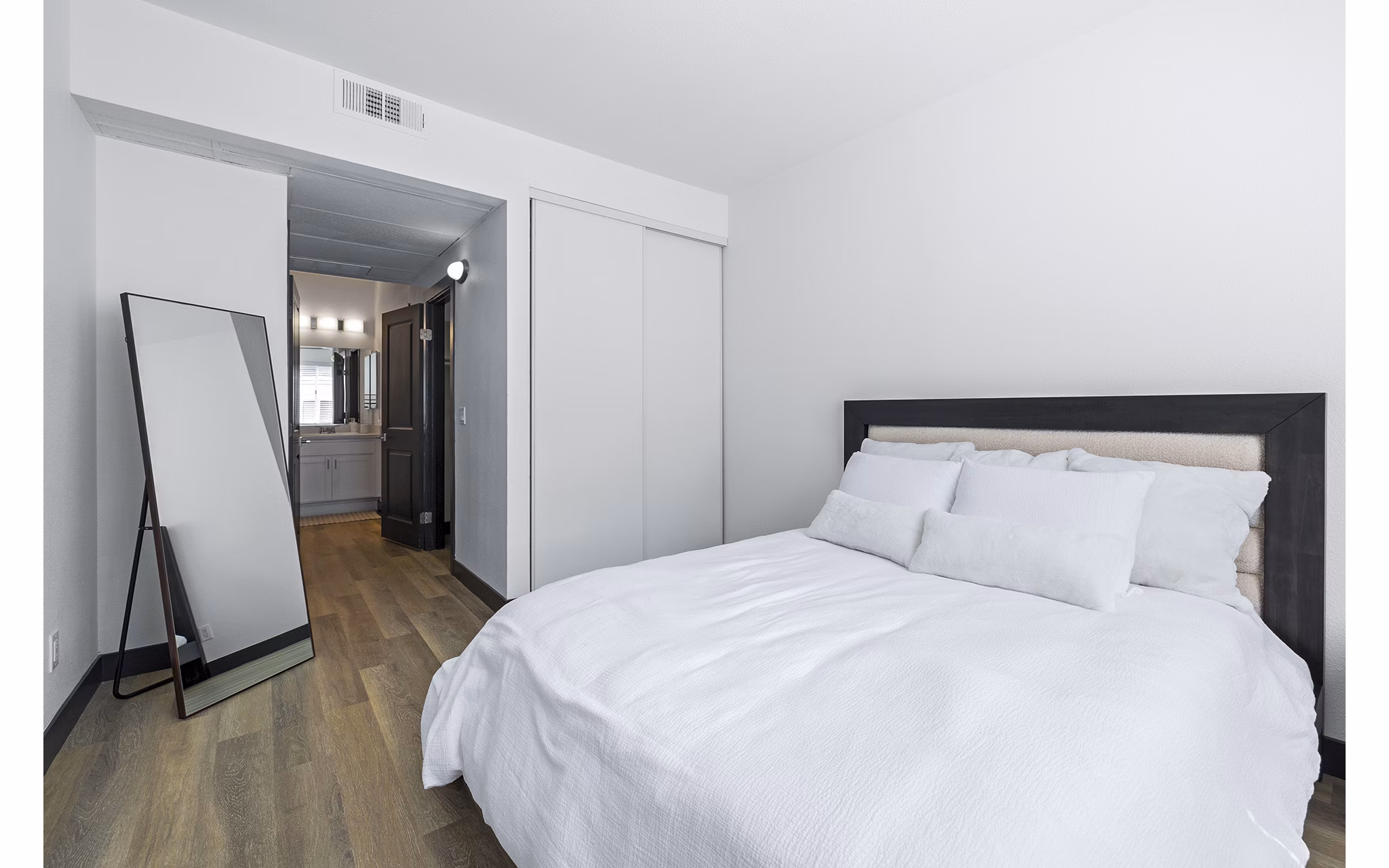 Cozy bedroom with natural light and modern decor at Enclave Apartments