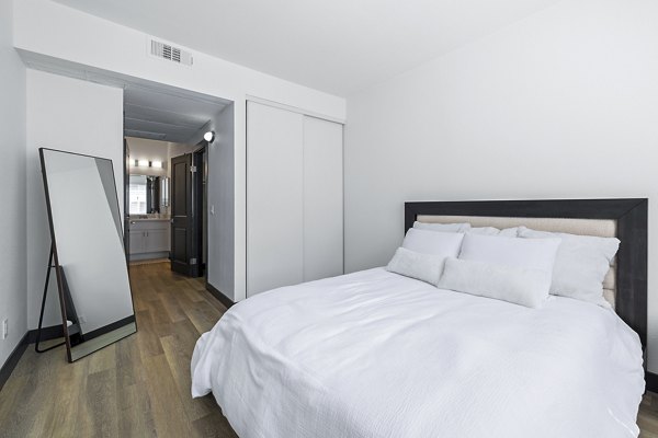 Cozy bedroom with natural light and modern decor at Enclave Apartments