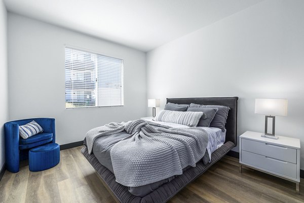 Cozy bedroom with modern decor at Enclave Apartments