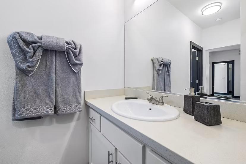 Bathroom featuring modern fixtures and marble countertops at Enclave Apartments, a luxury property by Greystar
