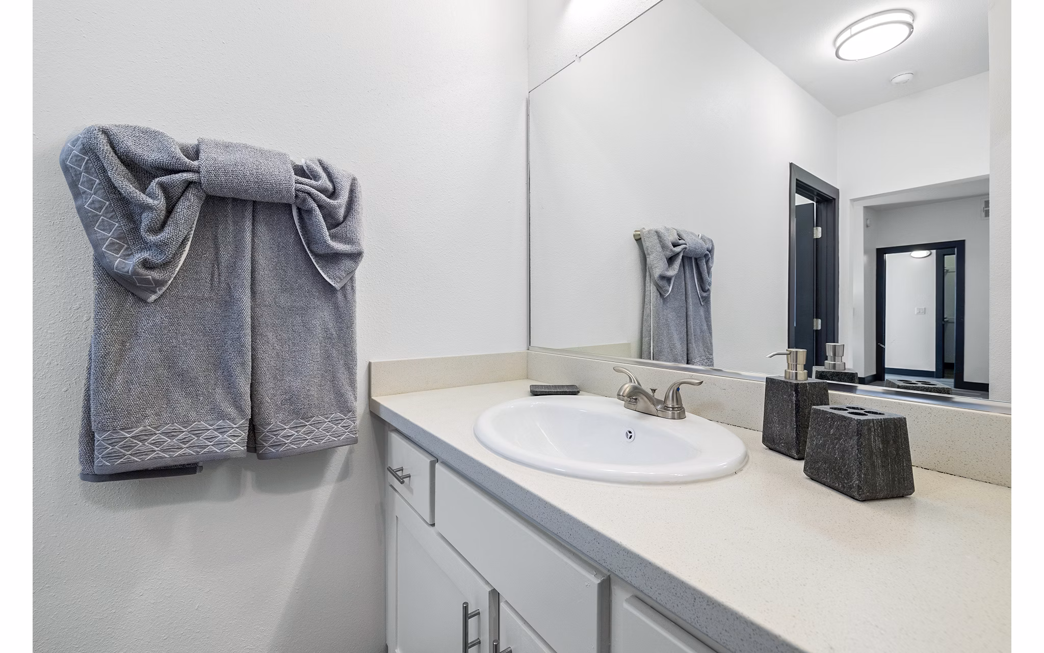 Bathroom featuring modern fixtures and marble countertops at Enclave Apartments, a luxury property by Greystar