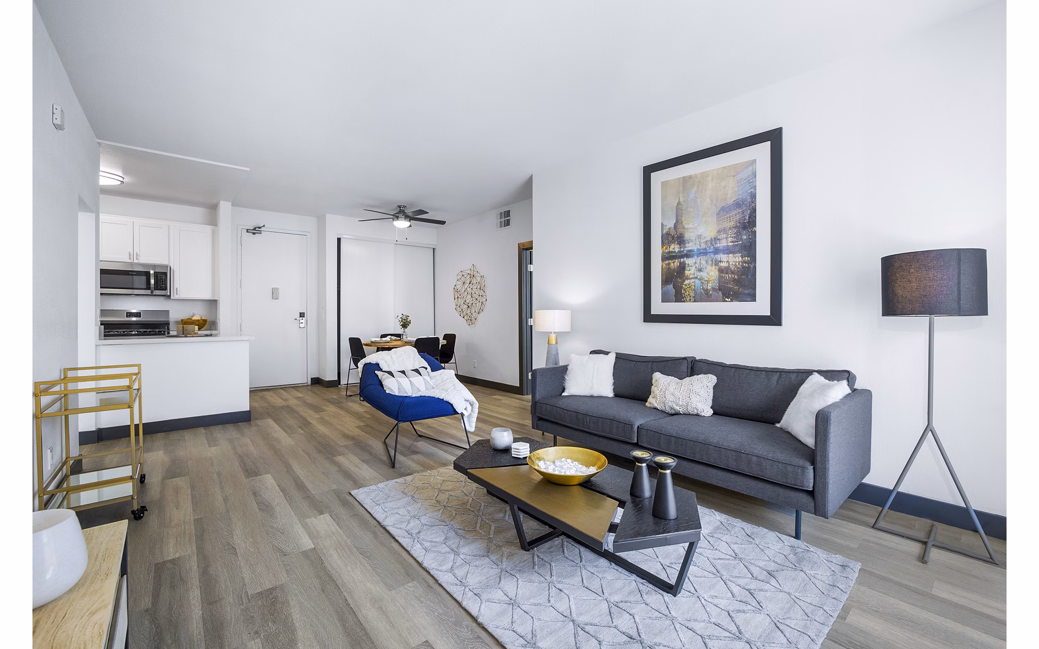 Bright living room with modern furniture and large windows in Enclave Apartments