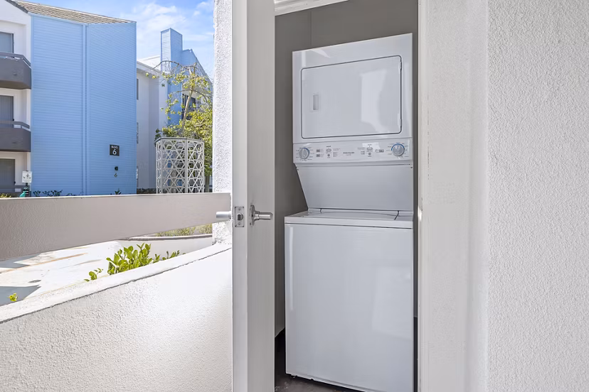 Laundry room with modern appliances at Enclave Apartments, luxury living by Greystar