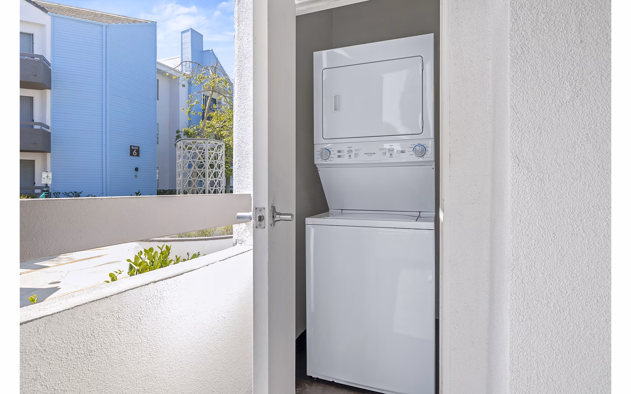 Laundry room with modern appliances at Enclave Apartments, luxury living by Greystar