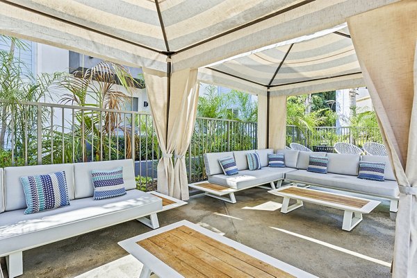 Patio with modern seating and lush landscaping at Enclave Apartments, luxury living by Greystar