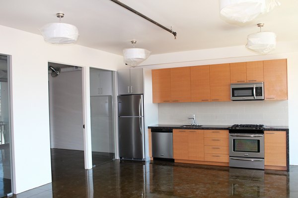 Modern kitchen with stainless steel appliances in Potrero Launch Apartments