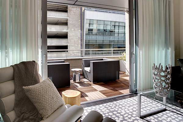 Outdoor patio featuring cozy seating and lush greenery at Potrero Launch Apartments, offering a relaxing retreat in urban living
