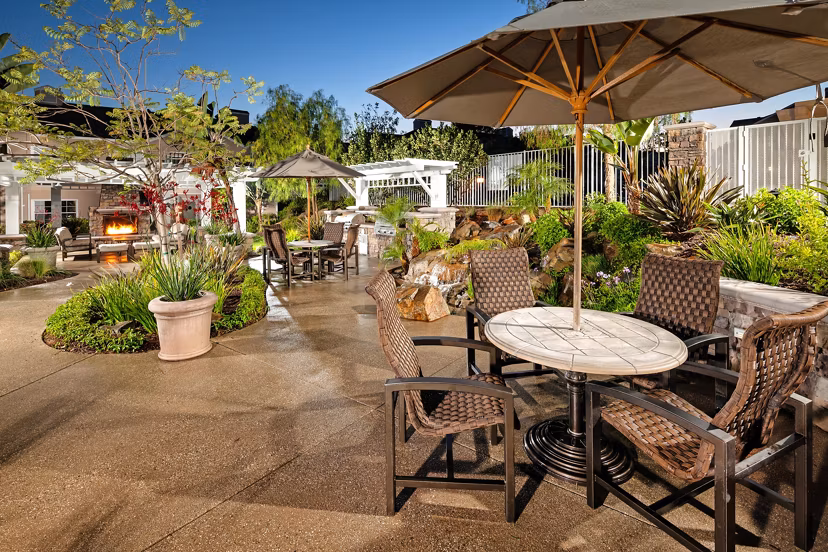 Grill area on a patio at Channel Point Apartments with outdoor seating for social gatherings Perfect for enjoying a sunny day with friends