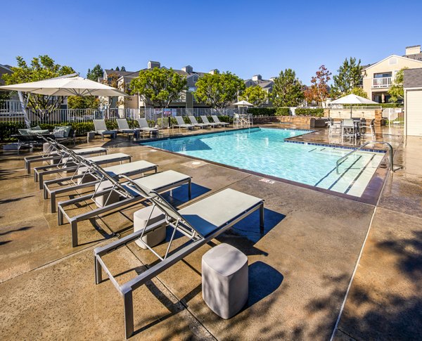 Expansive outdoor pool with lounge seating at Channel Point Apartments