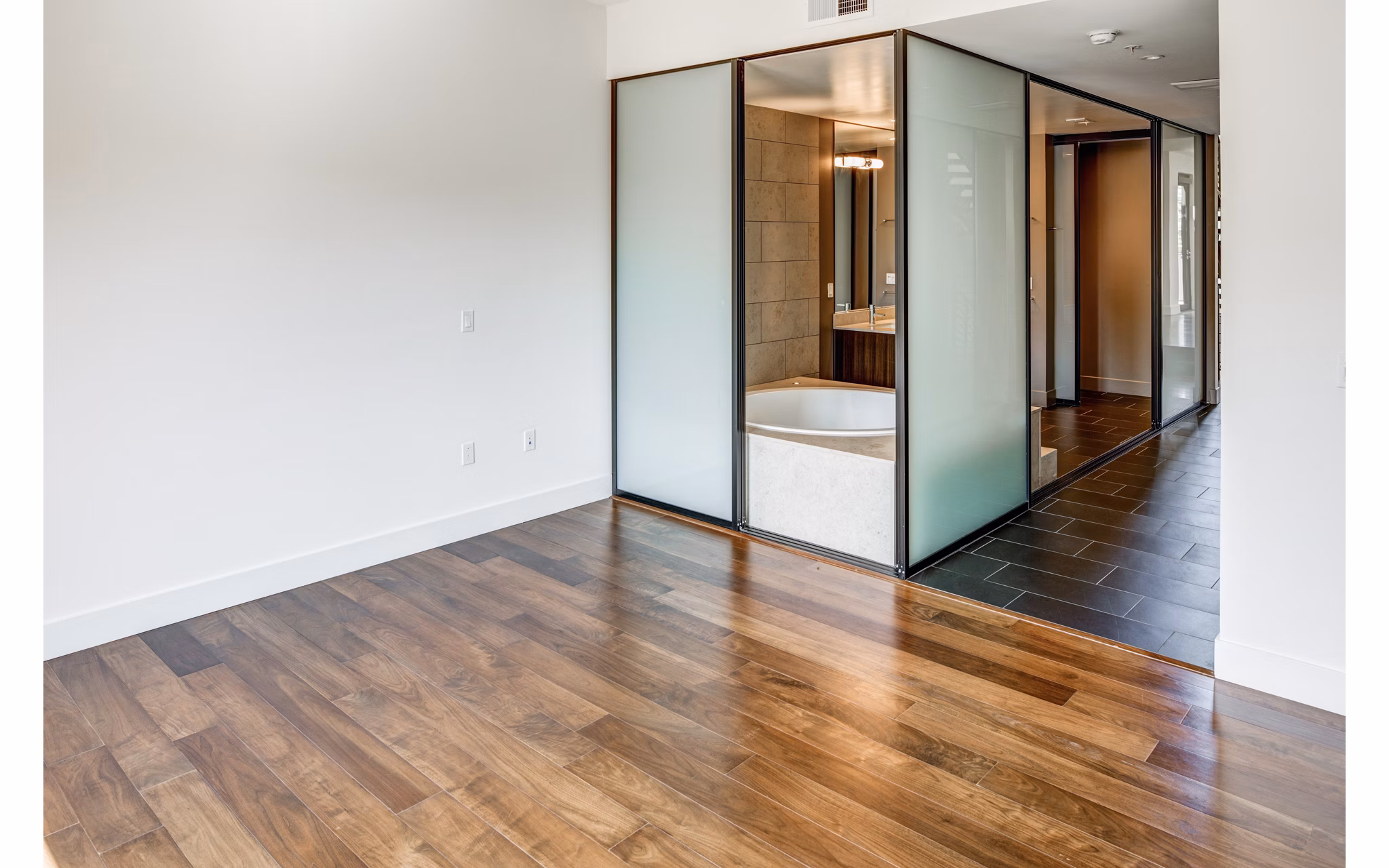 Elegant bedroom featuring modern decor and ample natural light at The Dudley Apartments