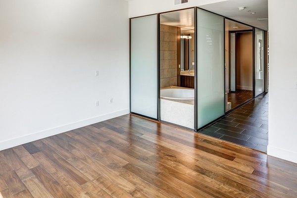 Elegant bedroom featuring modern decor and ample natural light at The Dudley Apartments