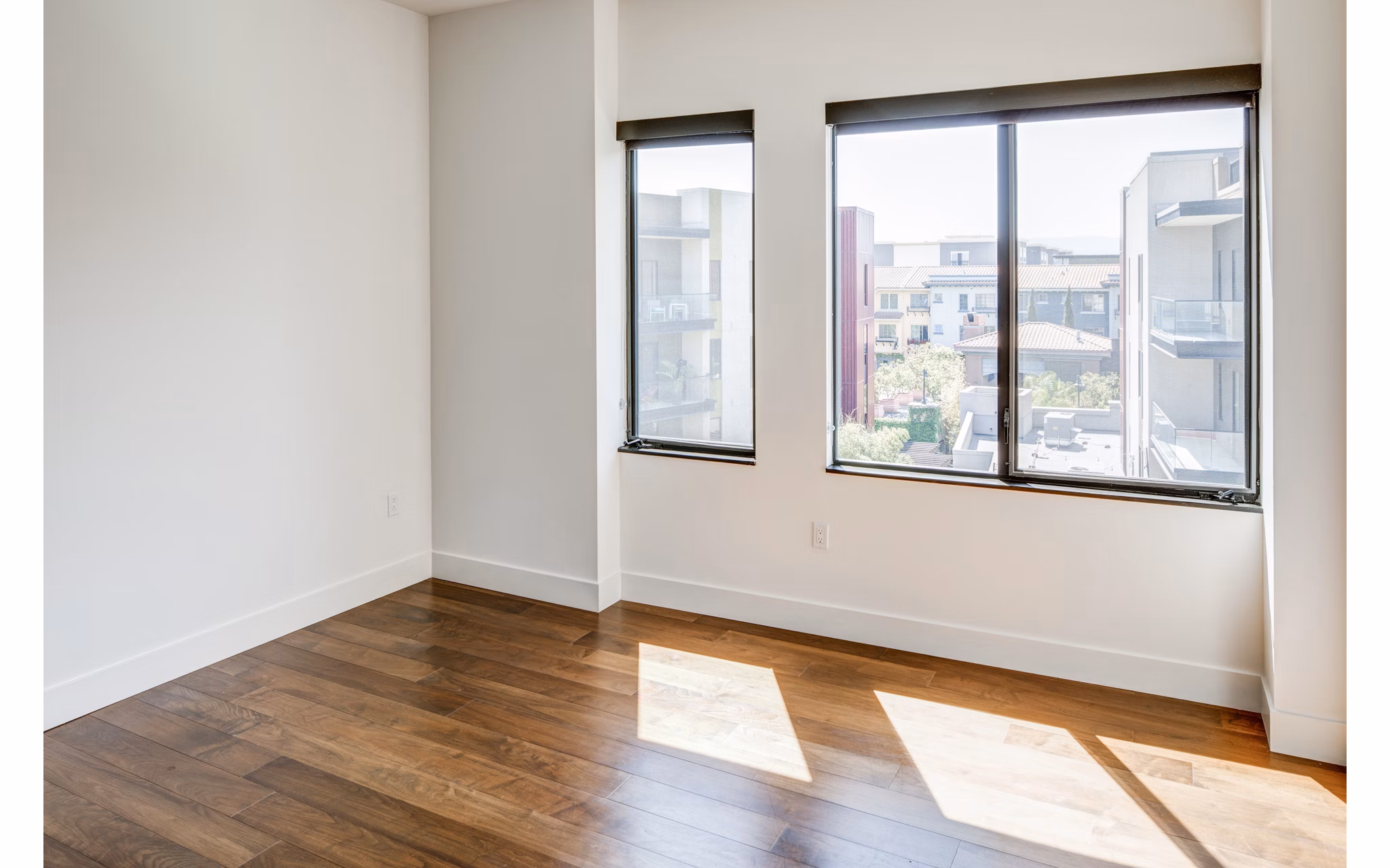 Cozy bedroom with modern decor at The Dudley Apartments, offering luxury living in a vibrant community