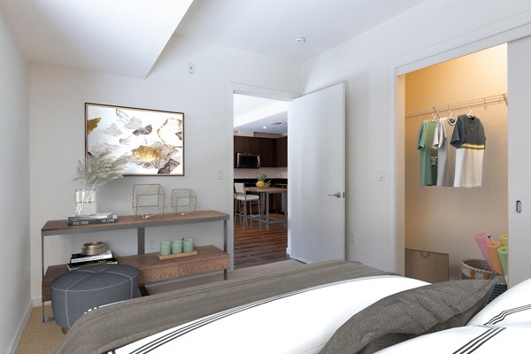 Spacious bedroom with modern furnishings at The Dudley Apartments, a luxury community by Greystar in an urban setting
