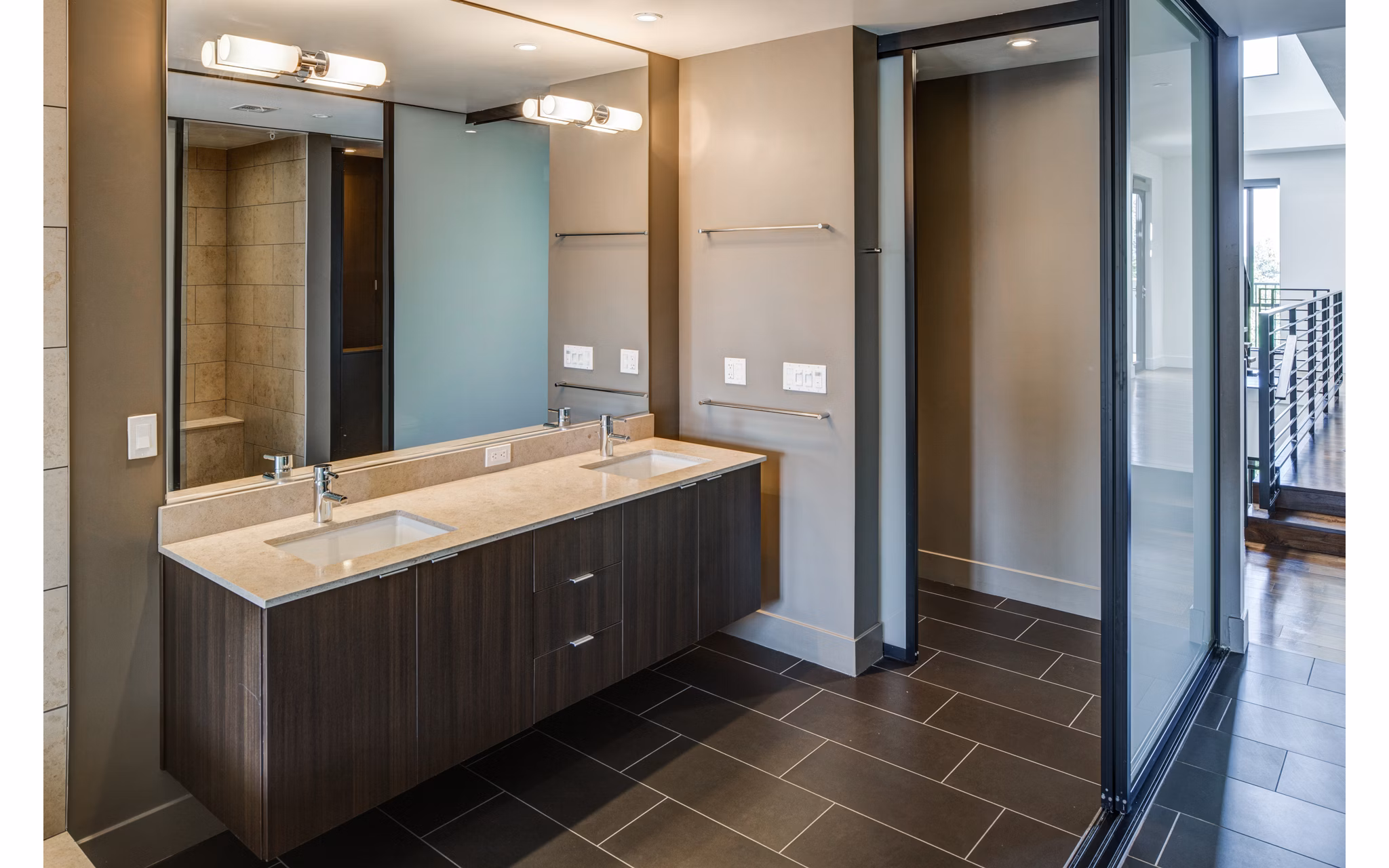 Stylish bathroom with marble countertops and modern fixtures at The Dudley Apartments