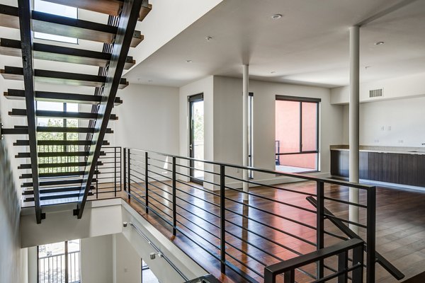 Clubhouse featuring modern design and cozy seating at The Dudley Apartments luxury community