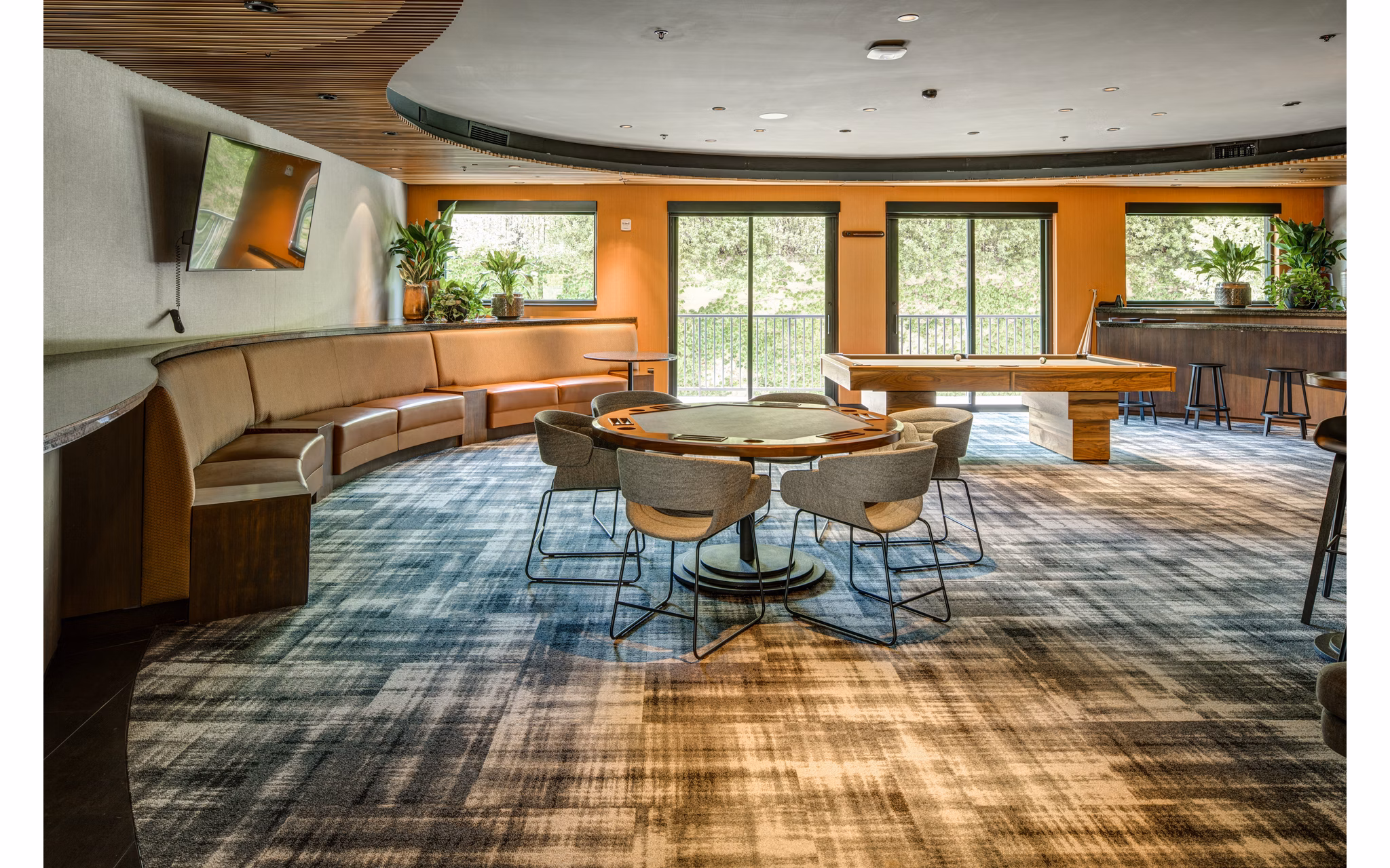 Clubhouse game room featuring billiards and lounge seating at The Dudley Apartments, Greystar luxury community