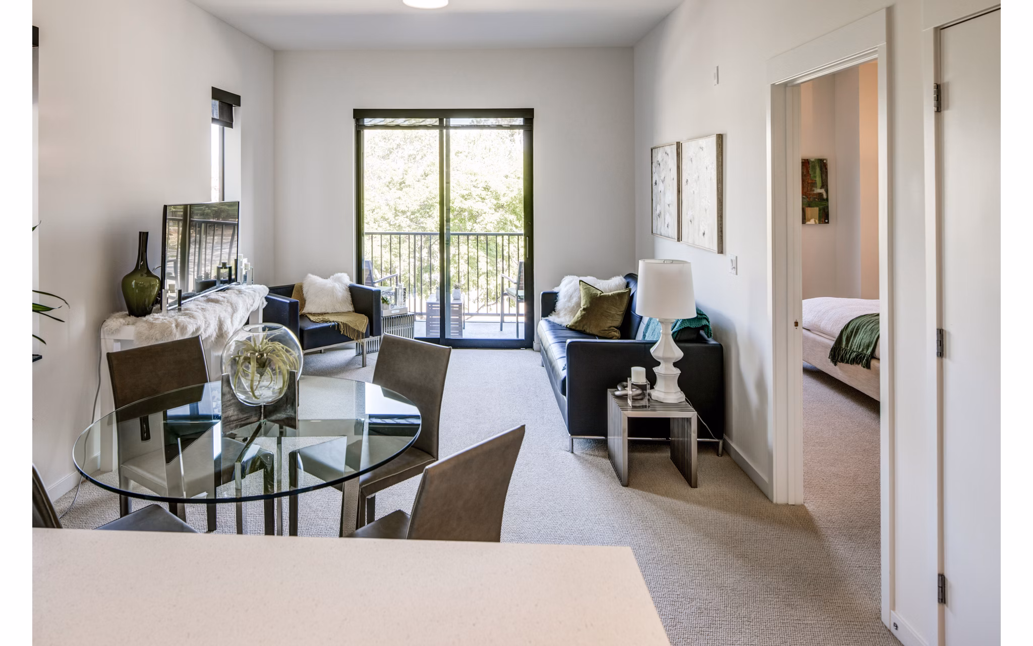 Dining room with modern decor at The Dudley Apartments featuring elegant dining set and contemporary lighting