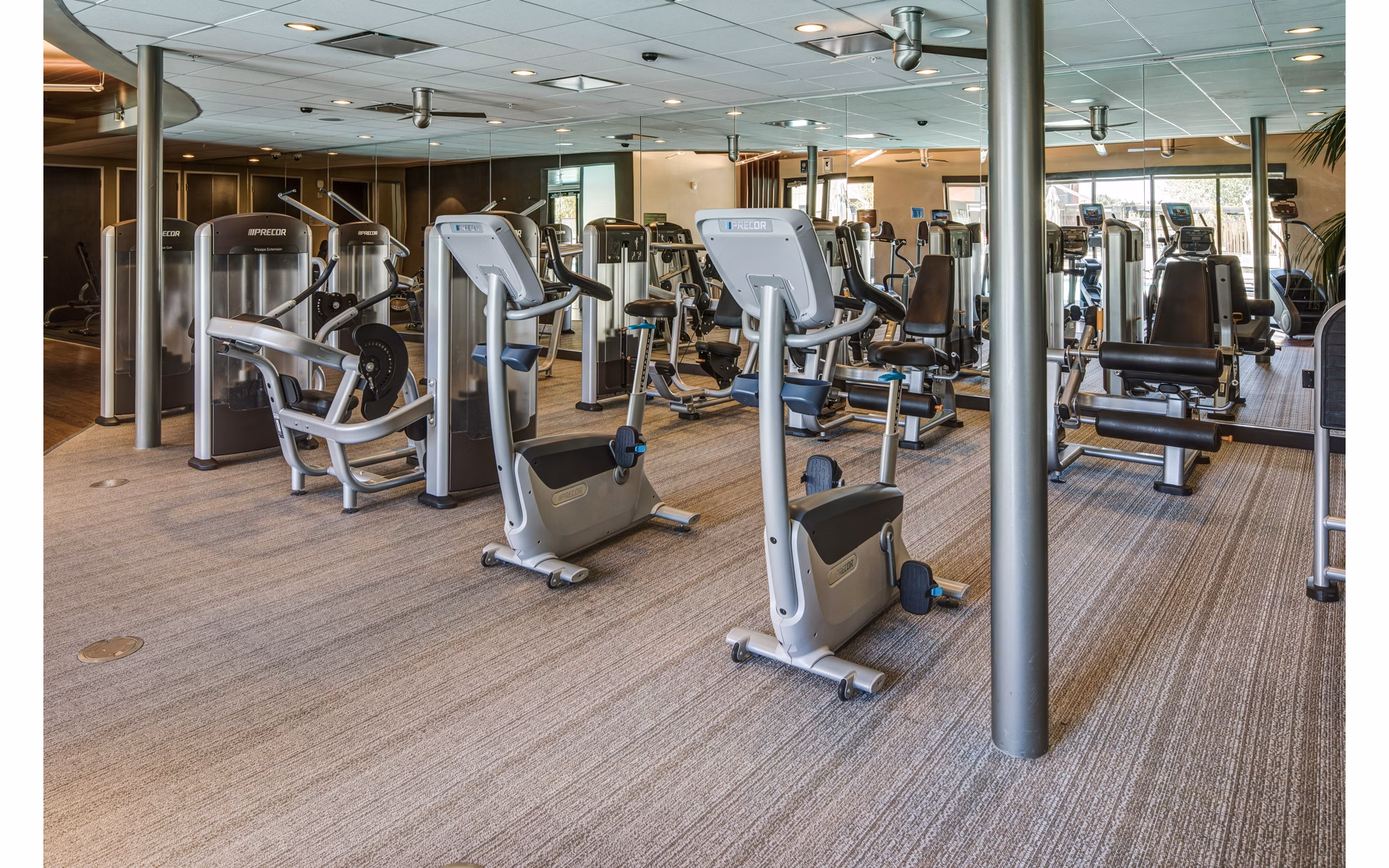 Fitness center equipped with modern exercise machines at The Dudley Apartments