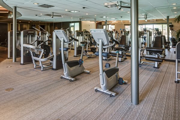 Fitness center equipped with modern exercise machines at The Dudley Apartments