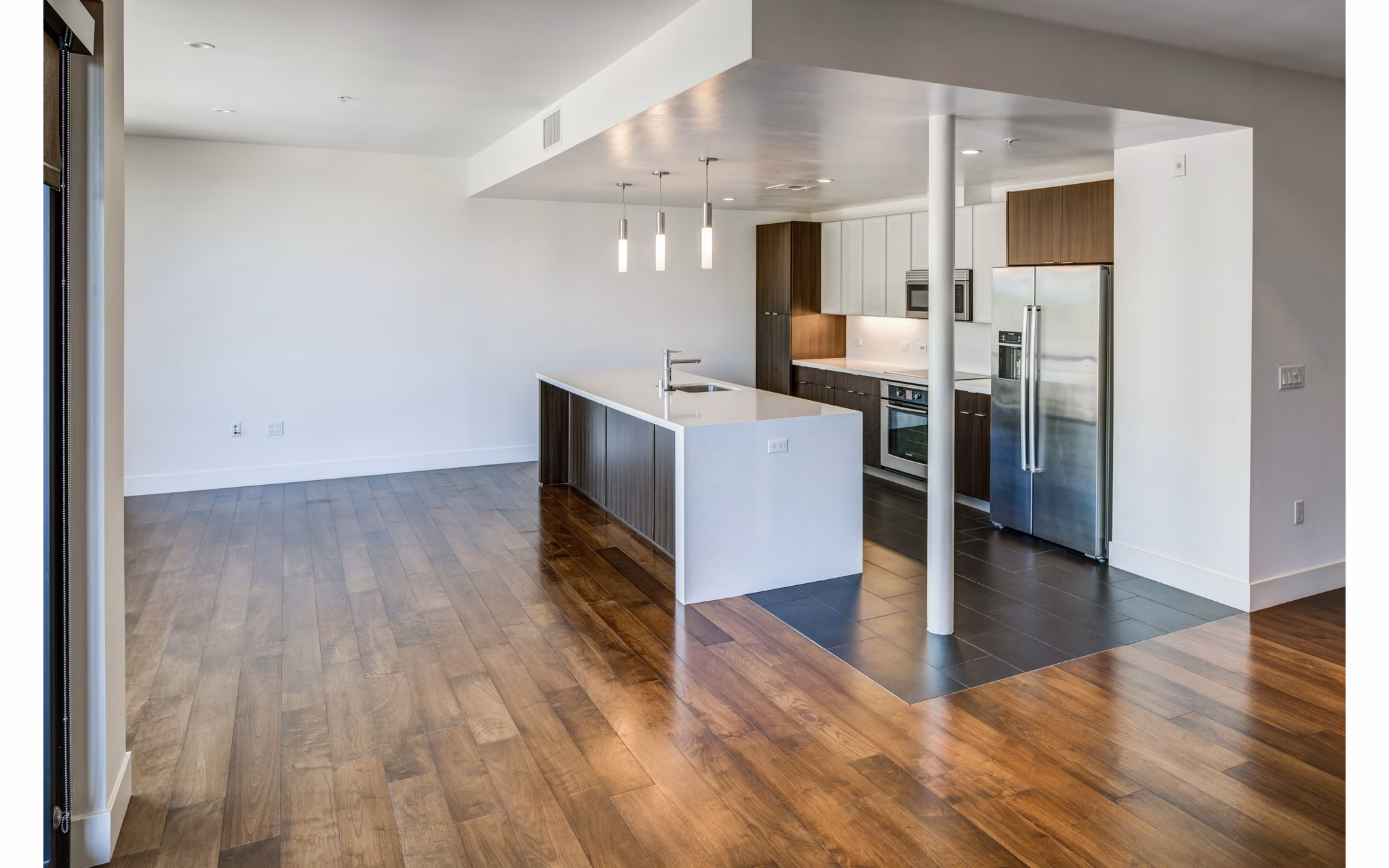 Modern kitchen with stainless steel appliances in The Dudley Apartments