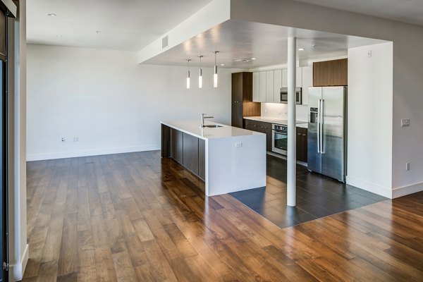 Modern kitchen with stainless steel appliances in The Dudley Apartments