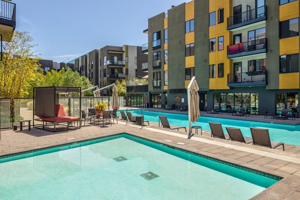 Luxurious outdoor pool area at The Dudley Apartments designed for relaxation and recreation, offering a serene oasis for residents