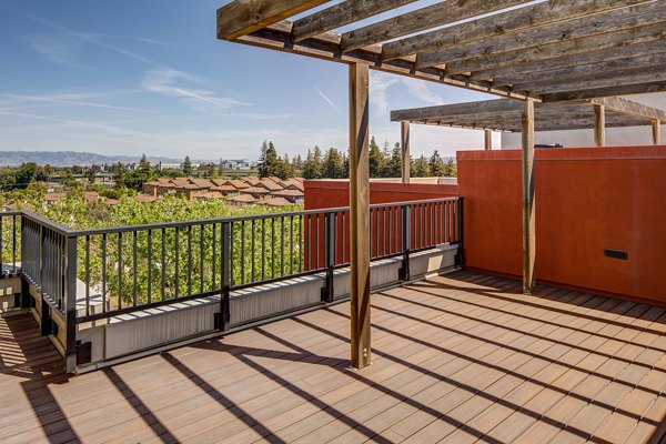 Stylish patio with cozy seating at The Dudley Apartments, offering outdoor relaxation in a luxury community setting