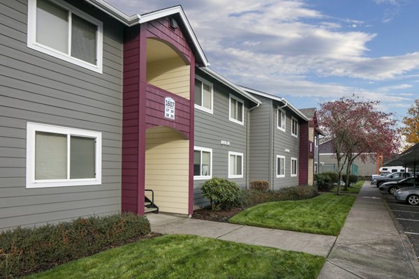 Creekside Apartments: Luxurious view of modern apartments surrounded by lush landscaping in a serene neighborhood